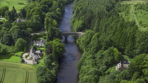 AX109_078.0000037F - Aerial stock photo of A bridge over River Teith among tree, Doune, Scotland