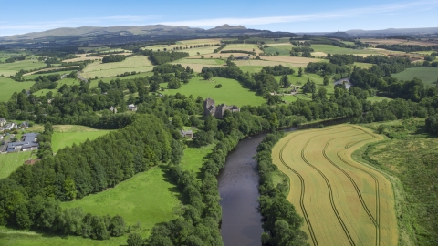 AX109_087.0000000F - Aerial stock photo of River Teith and historic Doune Castle near farmland, Scotland
