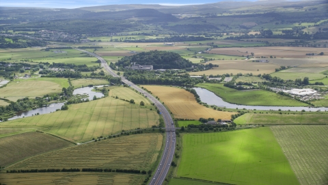 AX109_096.0000000F - Aerial stock photo of M9 highway and farmland in Stirling, Scotland