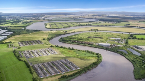 AX109_103.0000130F - Aerial stock photo of Riverfront warehouses by River Forth in Fallin, Scotland