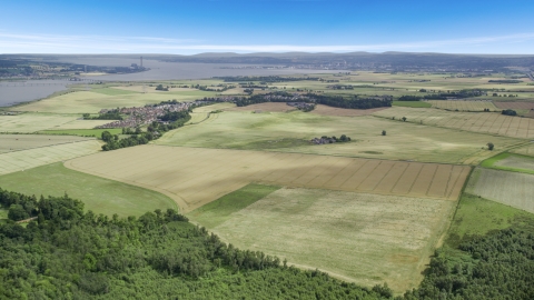AX109_110.0000217F - Aerial stock photo of Farm fields around the village of Airth, Scotland