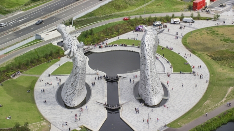 AX109_126.0000000F - Aerial stock photo of The Kelpies sculptures with tourists in Falkirk, Scotland