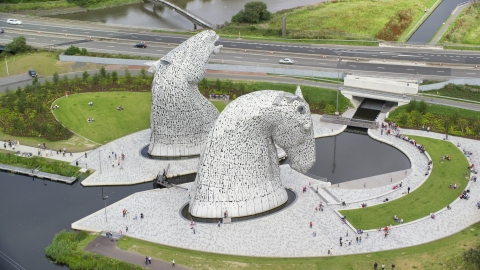 AX109_127.0000201F - Aerial stock photo of Profile view of The Kelpies sculptures in Falkirk, Scotland