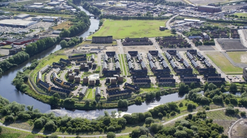 AX110_189.0000103F - Aerial stock photo of Riverfront row houses along River Clyde, Glasgow, Scotland