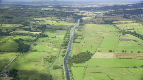 AX110_231.0000000F - Aerial stock photo of A river through farm fields in Cumbernauld, Scotland