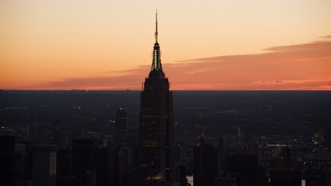 AX118_010.0000332F - Aerial stock photo of Sunrise at the Empire State Building in Midtown Manhattan, New York City