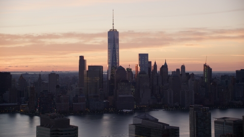 AX118_030.0000060F - Aerial stock photo of World Trade Center skyline across Hudson River at sunrise in Lower Manhattan, New York City