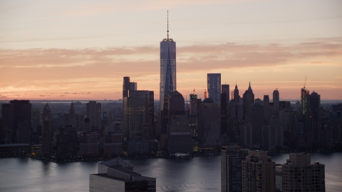 AX118_030.0000235F - Aerial stock photo of World Trade Center Skyline at sunrise in Lower Manhattan, New York City
