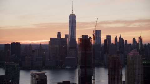 AX118_032.0000166F - Aerial stock photo of World Trade Center skyline at sunrise in Lower Manhattan, New York City, seen from Jersey City