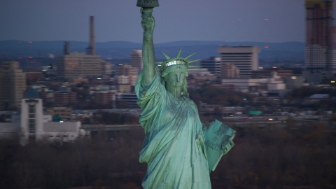 AX118_048.0000078F - Aerial stock photo of Front of the Statue of Liberty at sunrise, New York