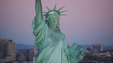 AX118_059.0000012F - Aerial stock photo of The Statue of Liberty at sunrise, New York