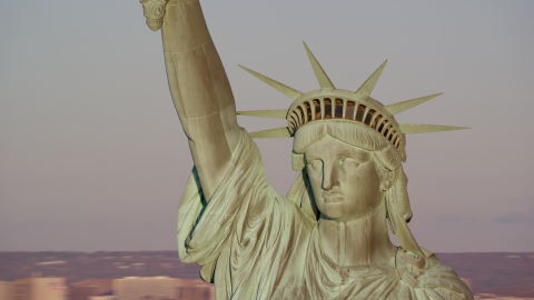 AX118_116.0000128F - Aerial stock photo of Close-up of the Statue of Liberty at sunrise in New York