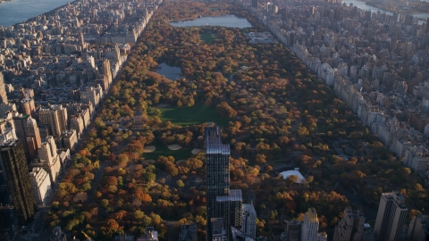 AX118_188.0000083F - Aerial stock photo of Central Park with autumn leaves at sunrise in New York City