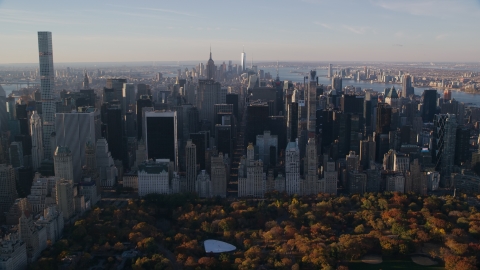 AX118_196.0000150F - Aerial stock photo of Midtown skyscrapers and Central Park in Autumn at sunrise in New York City