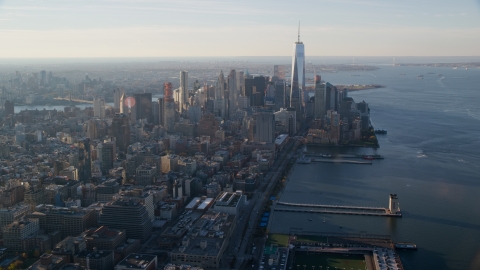 AX118_210.0000091F - Aerial stock photo of Pier 34 and Lower Manhattan at sunrise in New York City