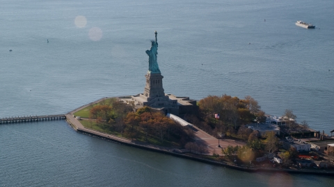 AX119_013.0000083F - Aerial stock photo of The back of Liberty Island and the Statue of Liberty in Autumn, New York