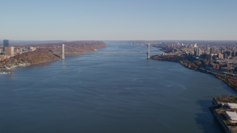 AX119_040.0000092F - Aerial stock photo of George Washington Bridge spanning the Hudson River in Autumn, New York City