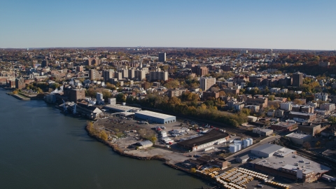 AX119_063.0000143F - Aerial stock photo of Riverfront warehouse buildings near downtown Yonkers, New York in Autumn