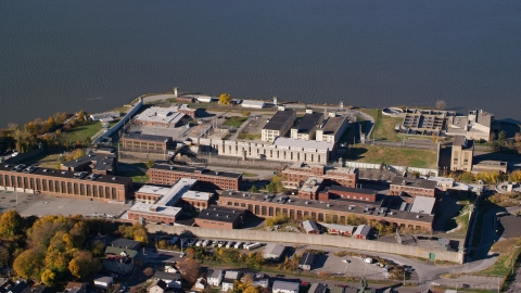 AX119_115.0000260F - Aerial stock photo of Riverfront Sing Sing Prison in Autumn, Ossining, New York