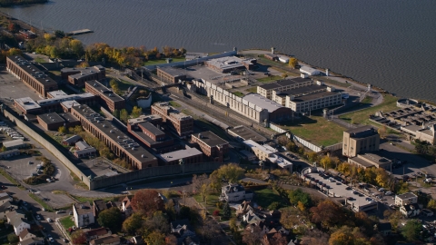 AX119_117.0000186F - Aerial stock photo of North side of Sing Sing Correctional Facility in Autumn, Ossining, New York