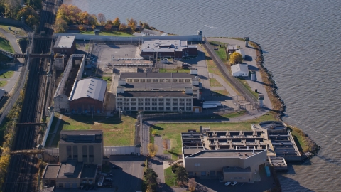 AX119_118.0000191F - Aerial stock photo of Sing Sing Correctional Facility complex in Autumn, Ossining, New York