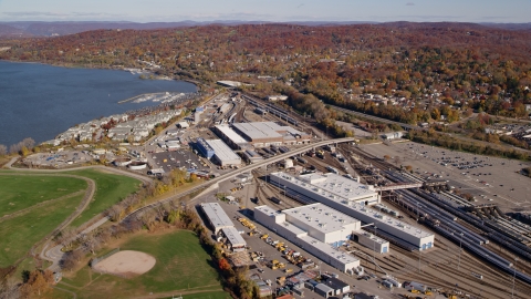 AX119_129.0000094F - Aerial stock photo of Riverfront rail station in Autumn, Croton on Hudson, New York