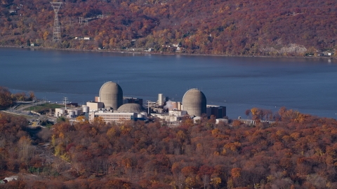AX119_144.0000113F - Aerial stock photo of The Indian Point Energy Center nuclear power plant in Autumn, Buchanan, New York