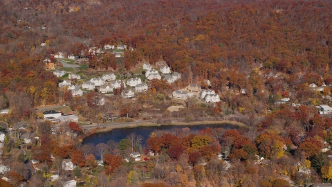 AX119_157.0000152F - Aerial stock photo of Condominium complexes overlooking Garrison Pond in Autumn, Fort Montgomery, New York
