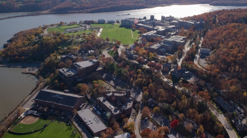 AX119_174.0000073F - Aerial stock photo of The West Point Military Academy by the Hudson River in Autumn, West Point, New York