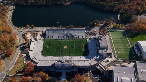 AX119_177.0000102F - Aerial stock photo of Michie Stadium, West Point Military Academy, New York in Autumn