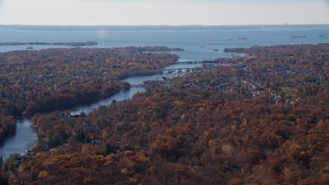 AX119_229.0000100F - Aerial stock photo of Small town community and bridges over Mianus River in Autumn, Greenwich, Connecticut