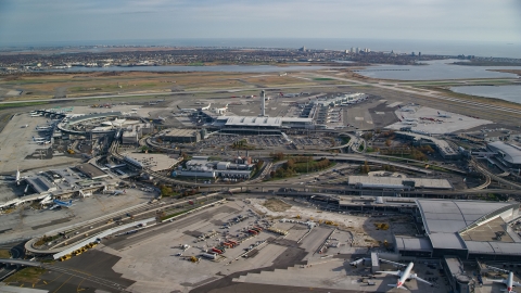 AX120_053.0000124F - Aerial stock photo of Control tower and terminals at JFK International Airport in Autumn, New York City