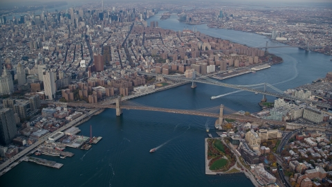 AX120_094.0000060F - Aerial stock photo of Brooklyn and Manhattan Bridges in Autumn, New York City
