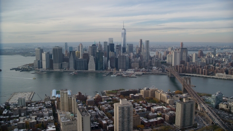 AX120_133.0000243F - Aerial stock photo of Lower Manhattan skyline across the East River, New York City