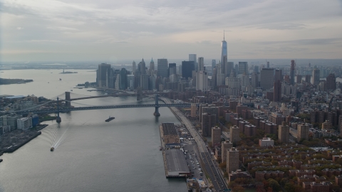 AX120_140.0000095F - Aerial stock photo of The Brooklyn and Manhattan Bridges beside Lower Manhattan, New York City