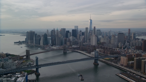 AX120_143.0000065F - Aerial stock photo of Manhattan Bridge, Brooklyn Bridge, East River, and Lower Manhattan, New York City