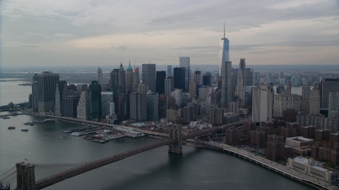 AX120_145.0000000F - Aerial stock photo of Brooklyn Bridge spanning East River by Lower Manhattan, New York City