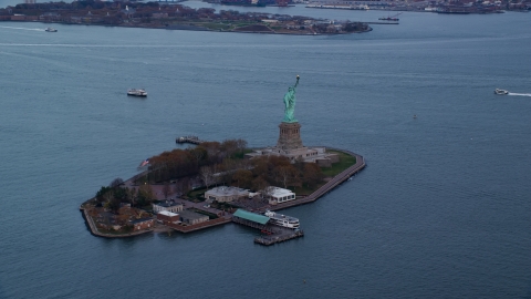AX121_013.0000082F - Aerial stock photo of The Statue of Liberty at sunset In Autumn, New York