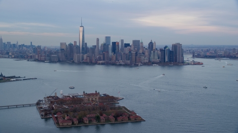 AX121_014.0000000F - Aerial stock photo of The Lower Manhattan skyline at sunset, New York City, seen from Ellis Island