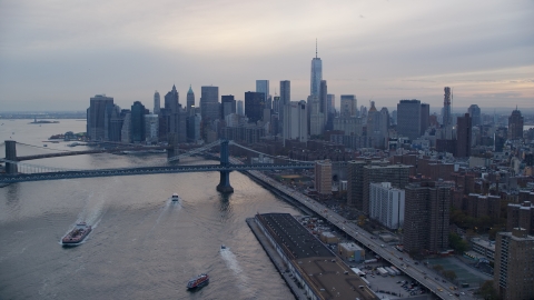 AX121_027.0000270F - Aerial stock photo of Manhattan Bridge and the Lower Manhattan skyline at sunset in New York City