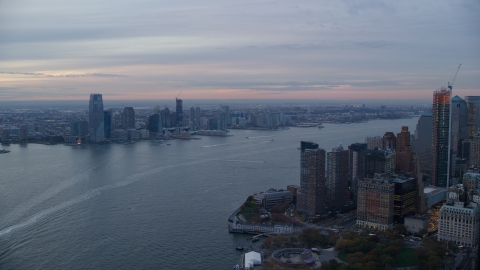 AX121_035.0000185F - Aerial stock photo of Downtown Jersey City, New Jersey at sunset seen across the Hudson River