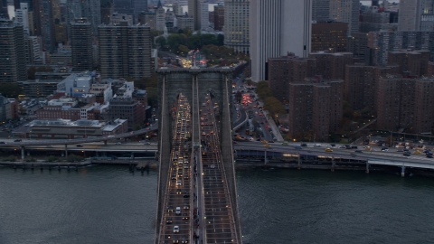 AX121_040.0000074F - Aerial stock photo of Heavy traffic on the Brooklyn Bridge at sunset in New York City