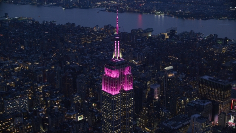 AX121_127.0000132F - Aerial stock photo of The Empire State Building with pink lights at sunset in Midtown, New York City
