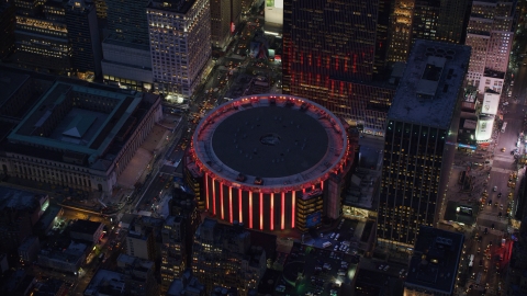 AX121_129.0000338F - Aerial stock photo of Madison Square Garden at sunset in Midtown Manhattan, New York City