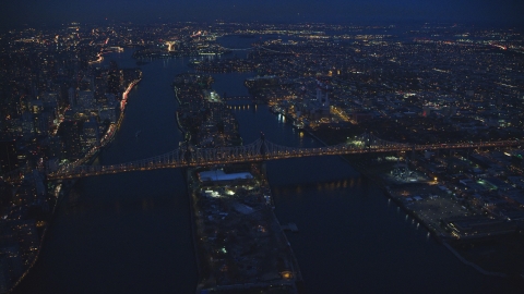 AX121_141.0000095F - Aerial stock photo of The Queensboro Bridge and Roosevelt Island at night in New York City