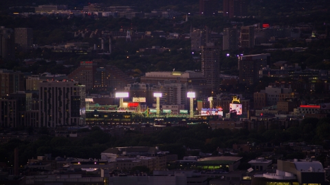 AX141_013.0000338 - Aerial stock photo of A baseball game and bright lights at Fenway Park, Boston, Massachusetts, twilight
