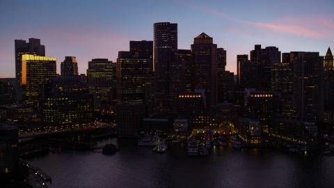 AX141_024.0000168 - Aerial stock photo of Skyline and Rowes Wharf, Downtown Boston, Massachusetts, twilight