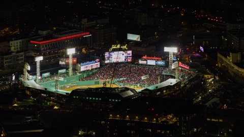 AX141_132.0000000 - Aerial stock photo of A baseball game at Fenway Park stadium in Boston, Massachusetts, night