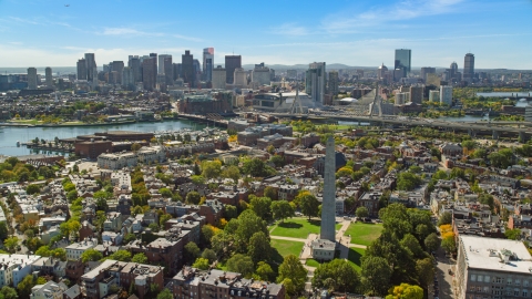 AX142_195.0000181 - Aerial stock photo of Bunker Hill Monument and the Downtown Boston skyline, Charlestown, Massachusetts