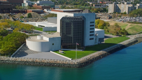 AX142_222.0000133 - Aerial stock photo of The John F. Kennedy Presidential Library beside a bay, Boston, Massachusetts